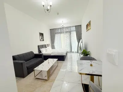 a living room with a couch and a table at A place like home in Dubai