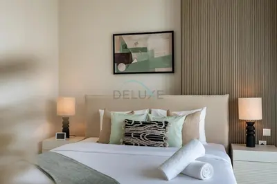 a bedroom with a large white bed with two lamps at Spacious 3BR Living, Walking Distance to Dubai Water Canal and Park, Near Safa Park Marine Transport Station, Canal Front 9B, Al Wasl by Deluxe Holiday Homes in Dubai