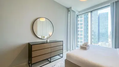 a bedroom with a mirror and a bed and a dresser at Exclusive 1BR, Panoramic Marina View, Dubai Marina - 21AB02 in Dubai