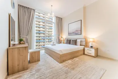 a bedroom with a bed and a large window at Walking distance to Dubai Mall and Burj Khalifa, Easy access to Dubai Metro and Top attractions, Dunya Tower, Downtown Dubai by Deluxe Holiday Homes in Dubai