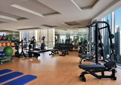 a gym with treadmills and exercise equipment in a building at JW Marriott Marina Residences in Dubai