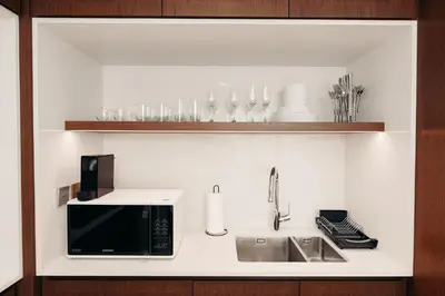 a kitchen counter with a microwave and a sink at Beachfront Luxury 2BR with Breathtaking Views in Dubai