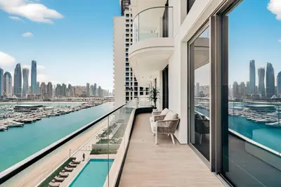 a balcony of a building with a view of a harbor at Beachfront Luxury 2BR with Breathtaking Views in Dubai