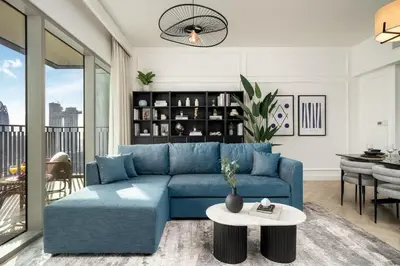 a living room with a blue couch and a table at 4BR Gem in Downtown with Full Burj Khalifa View and Dubai Mall Access in Dubai