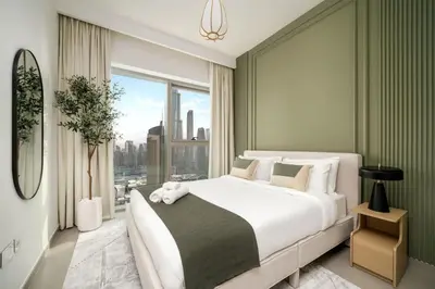 a bedroom with a large bed and a large window at 4BR Gem in Downtown with Full Burj Khalifa View and Dubai Mall Access in Dubai