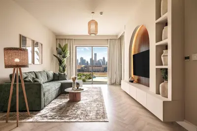 a living room with a green couch and a television at 2BR Gem with Burj Khalifa View and Dubai Mall Access in Dubai