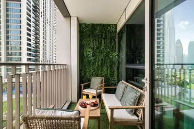 a balcony with chairs and a table with a laptop on it at 2BR Gem with Burj Khalifa View and Dubai Mall Access in Dubai