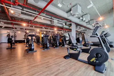 a gym with several treadmills and cardio machines at 2BR Gem with Burj Khalifa View and Dubai Mall Access in Dubai