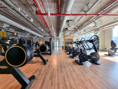 a gym with rows of treadmills and machines at 2BR Gem with Burj Khalifa View and Dubai Mall Access in Dubai