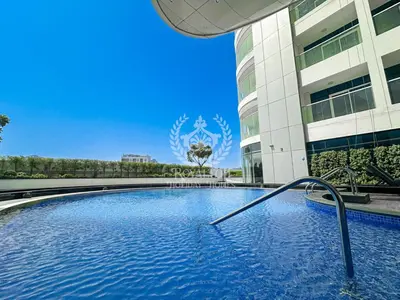 a large swimming pool in front of a building at Royalton - Private Pool Luxe Studio in Dubai in Dubai