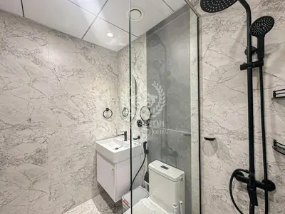 a bathroom with a shower and a toilet and a sink at Royalton - Private Pool Luxe Studio in Dubai in Dubai