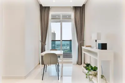 a white room with a desk and a window at Elegant Studio in Business Bay near Burj Khalifa in Dubai