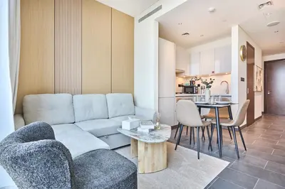 a living room with a couch and a table at STAY BY LATINEM Luxury 1BR Holiday Home CB 1807 Near Downtown in Dubai