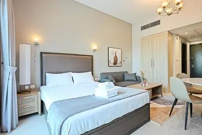 a hotel room with a bed and a couch at Luxury Studio Near Downtown Dubai in Dubai