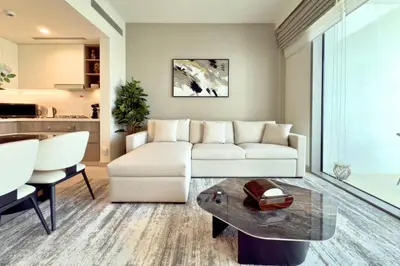 a living room with a white couch and a table at Luxury 1-Bedroom Apartment with Full Marina View in Dubai