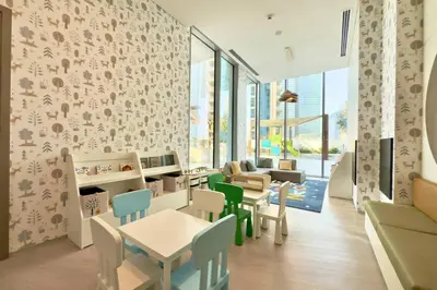 a childrens waiting area with tables and chairs at Luxury 1-Bedroom Apartment with Full Marina View in Dubai