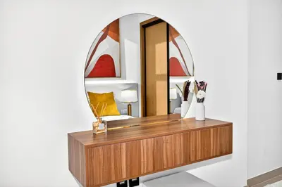 a dressing table in front of a mirror at Golden Stays - Private Pool in Binghatti Gardenia I Coastal Charm I Luxe 2BR Escape in Dubai
