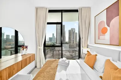 a bedroom with a bed and a large window at Golden Stays - Private Pool in Binghatti Gardenia I Coastal Charm I Luxe 2BR Escape in Dubai