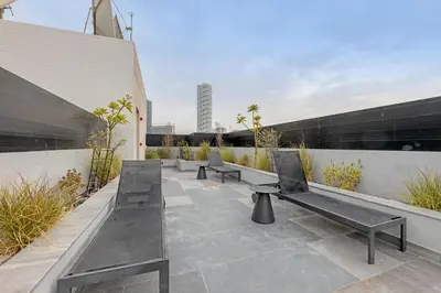 a row of benches sitting on top of a building at Waves - Cozy & Modern JVC Escape With Pool & Gym Access in Dubai