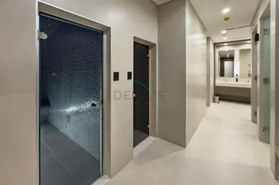 a walk in shower with a glass door in a bathroom at Panoramic High-Floor 1BR Overlooking Yachts and Dubai Water Canal, Moments from JBR Beach, LIV MarinaMarine Transport, and Skydive Dubai, LIV Marina, Dubai Marina by Deluxe Holiday Homes in Dubai