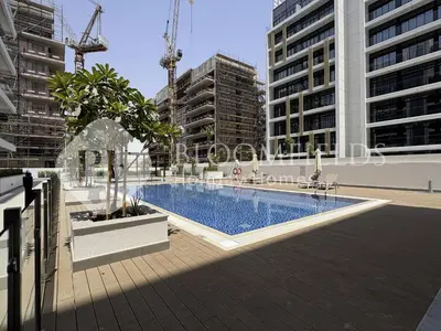 a swimming pool in a city with tall buildings at Bloomfeilds Comfortable STU Azizi Rivera in Dubai