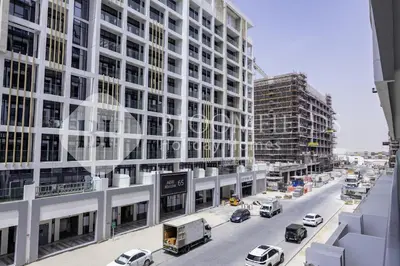 a city street with traffic in front of tall buildings at Bloomfeilds Comfortable STU Azizi Rivera in Dubai