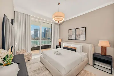 a bedroom with a white bed and a large window at Luxury 2BR Retreat Gorgeous Beach & Skyline Views in Dubai