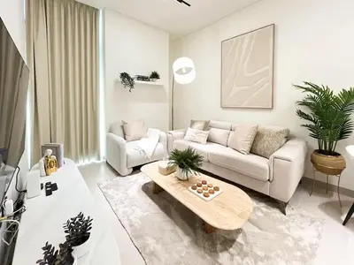 a living room with a couch and a coffee table at Serene Palette 1BR in Binghatti Azure with Gym & Pool in Dubai