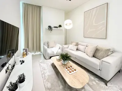a living room with a white couch and a coffee table at Serene Palette 1BR in Binghatti Azure with Gym & Pool in Dubai