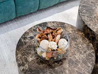 a glass bowl filled with shells on a table at Livin' Holidays - Studio - Bay View with Jacuzzi in Dubai