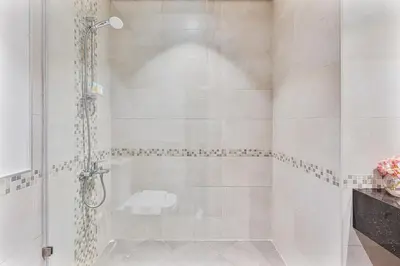 a bathroom with a shower with a glass door at Radiant - 3BR - JVC - near Sports City & Autodrome in Dubai