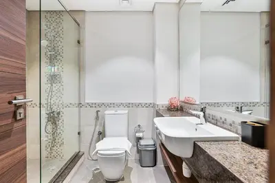 a bathroom with a toilet and a sink and a shower at Radiant - 3BR - JVC - near Sports City & Autodrome in Dubai