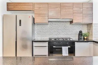 a kitchen with a stove and a refrigerator at Radiant - 3BR - JVC - near Sports City & Autodrome in Dubai