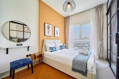 a bedroom with a large bed and a window at 1BR in Collective With Pool, Gym and CoWorking Space in Dubai