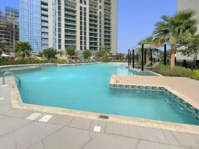 a large swimming pool in the middle of a city at Chic Studio in Dubai with Pool View Retreat Near Business Bay & Jumeirah Beach in Dubai