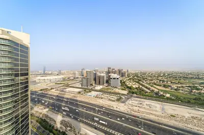 an aerial view of a city with a highway at Stylish 2BR JVC with Pool, Gym Access, and City Skyline Views in Dubai