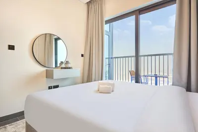 a bedroom with a large bed and a large window at STAY BY LATINEM Luxury 1BR Holiday Home CB 3015 Near Burj Khalifa in Dubai
