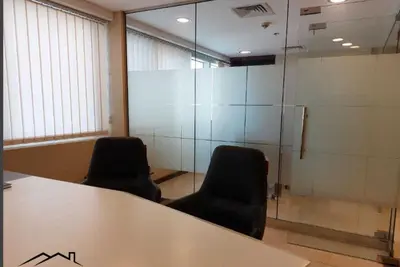 an office with two chairs and a table and glass wall at Sobha Creek Vistas Reserve, Sobha Hartland, Dubai in Dubai