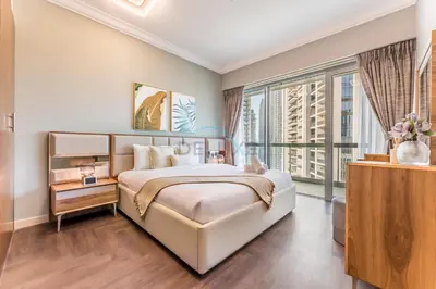 a bedroom with a large bed and a large window at Apartment near Burj Khalifa and Dubai Mall, Central Location, Minutes to Dubai Marina and Palm Jumeirah - 8 BLVD Walk, Downtown Dubai by Deluxe Holiday Homes in Dubai