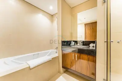 a bathroom with a bath tub and a sink at Apartment near Burj Khalifa and Dubai Mall, Central Location, Minutes to Dubai Marina and Palm Jumeirah - 8 BLVD Walk, Downtown Dubai by Deluxe Holiday Homes in Dubai