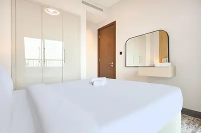 a white room with a mirror and a bed at STAY BY LATINEM Luxury 1BR Holiday Home CB 0902 Near Burj Khalifa in Dubai