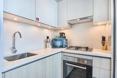 a kitchen with a sink and a stove at STAY BY LATINEM Luxury 1BR Holiday Home CB 0902 Near Burj Khalifa in Dubai