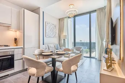 a kitchen and dining room with a table and chairs at STAY BY LATINEM Luxury 1BR Holiday Home CB 0902 Near Burj Khalifa in Dubai