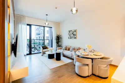 a living room with a couch and a table at Stylish Apartment in La Mer Dubai in Dubai