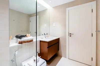 a bathroom with a toilet and a sink and a shower at Stylish Apartment in La Mer Dubai in Dubai