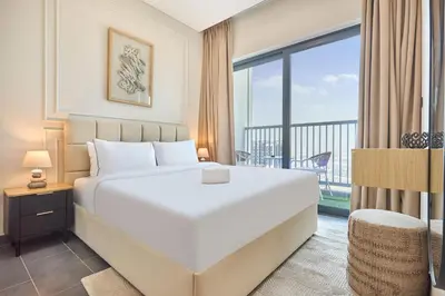 a bedroom with a large white bed and a balcony at STAY BY LATINEM Luxury 1BR Holiday Home CB 1409 Near Burj Khalifa in Dubai
