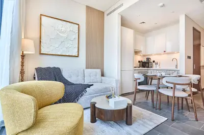 a living room with a couch and a table at STAY BY LATINEM Luxury 1BR Holiday Home CB 1409 Near Burj Khalifa in Dubai