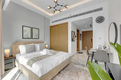 a bedroom with a large bed and a desk at Chic Dubai Retreat at Azizi Riviera 65 in Dubai