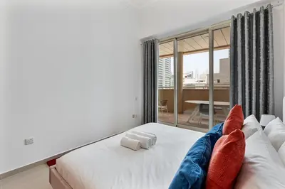 a bedroom with a bed with two pillows on it at Retro 1BR APT in Marina Near JBR Beach & Mall in Dubai