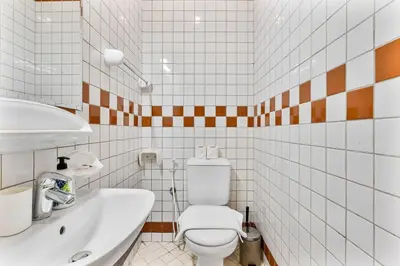 a white bathroom with a toilet and a sink at Retro 1BR APT in Marina Near JBR Beach & Mall in Dubai